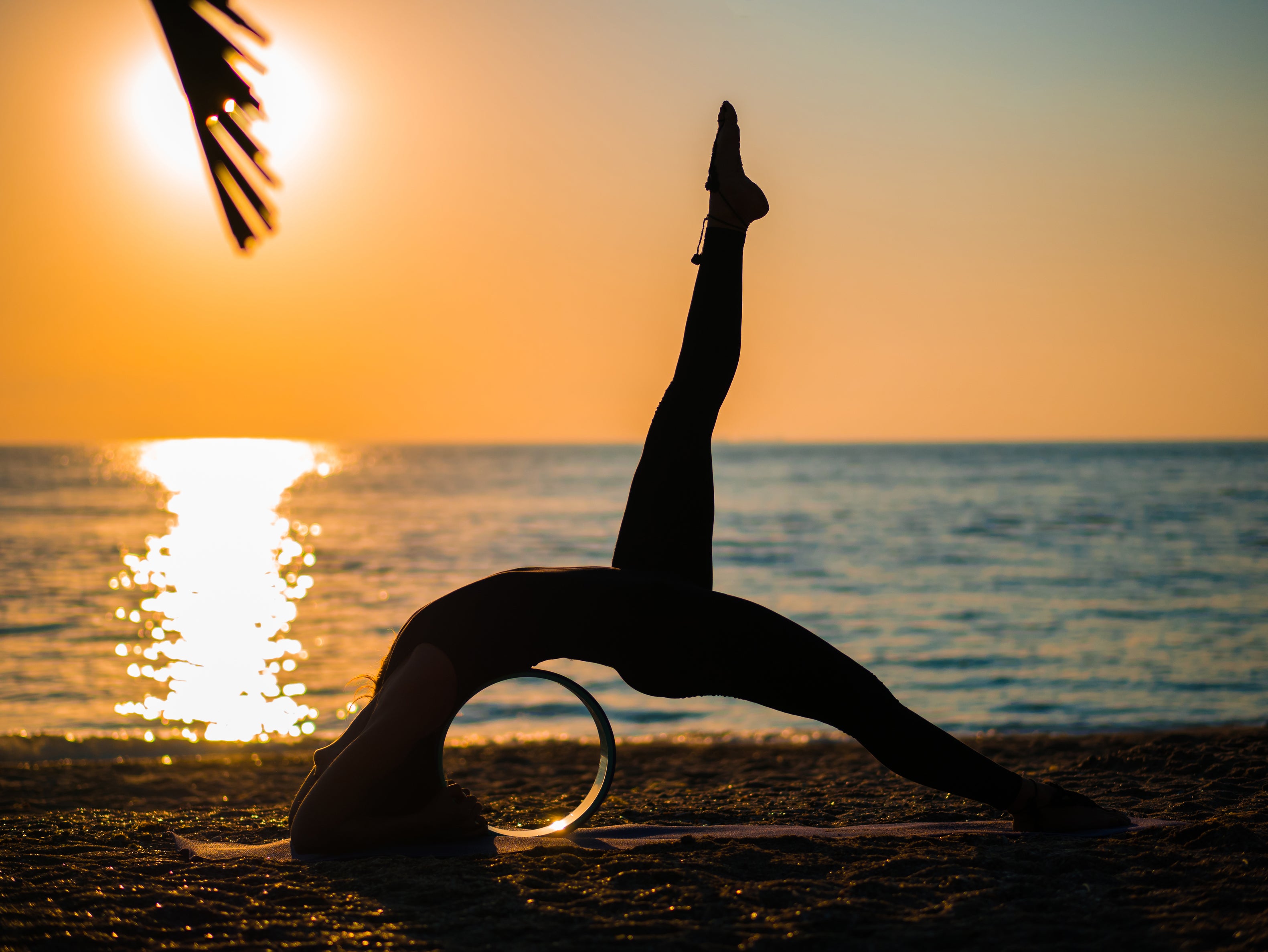 Woman doing yoga on beach